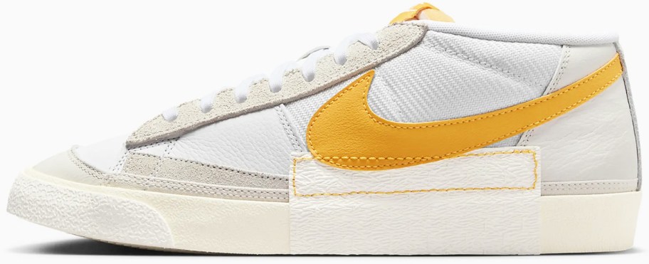 white low cut sneaker with yellow nike logo