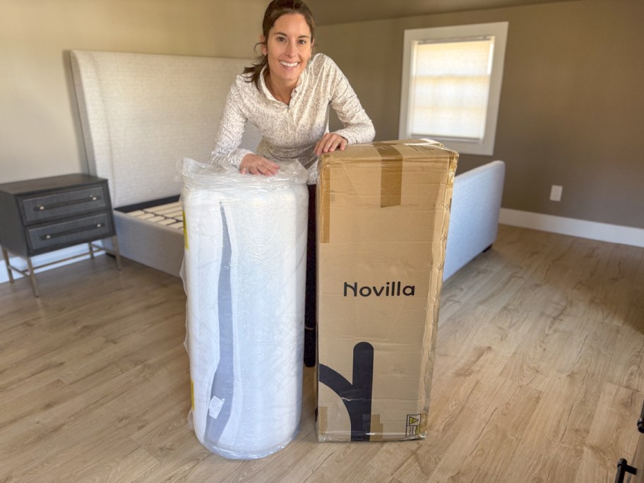 Woman standing next to her mattress in a box by Novilla