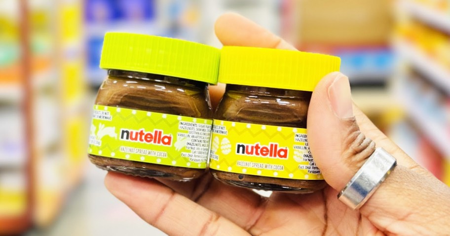 hand holding up green and yellow Nutella Mini Jars