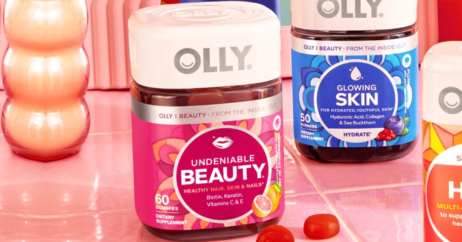 bottles of olly vitamins on pink tiles