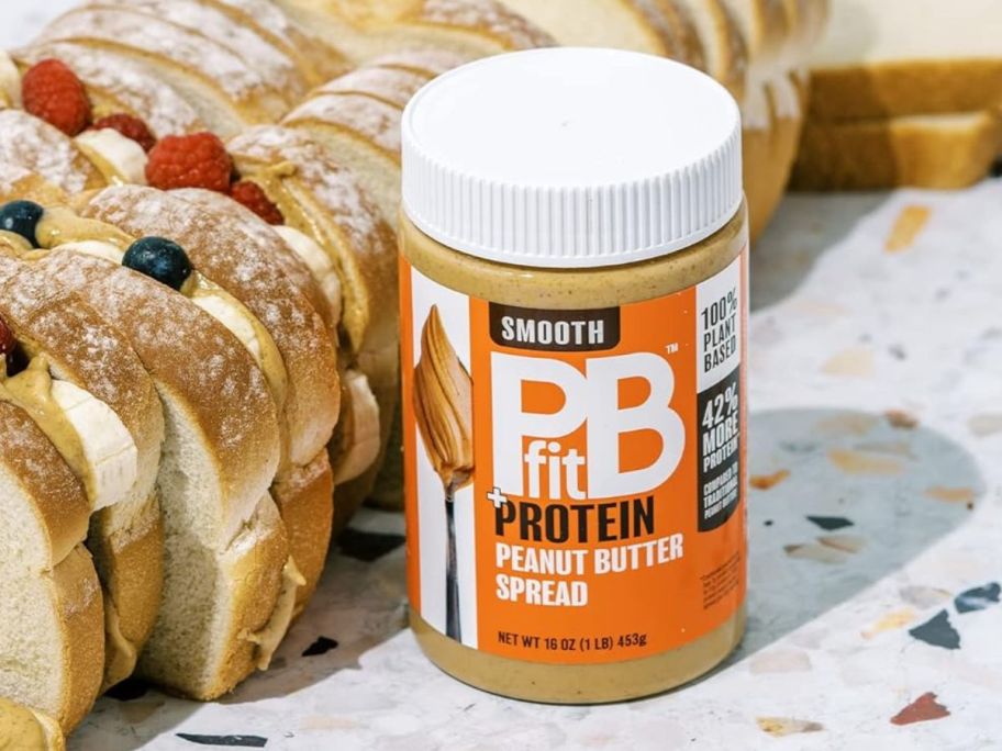 PBfit Peanut Butter Spread 16oz next to bread