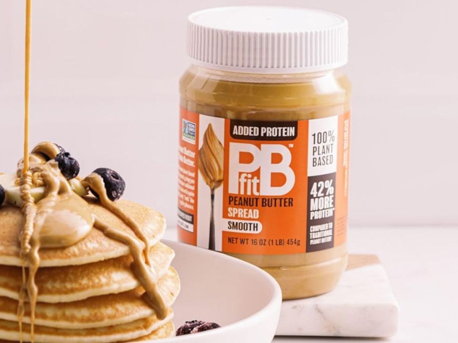 PBfit Peanut Butter Spread 16oz next to pancakes