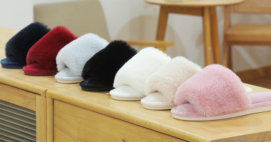 row of faux fur slippers on wood desk