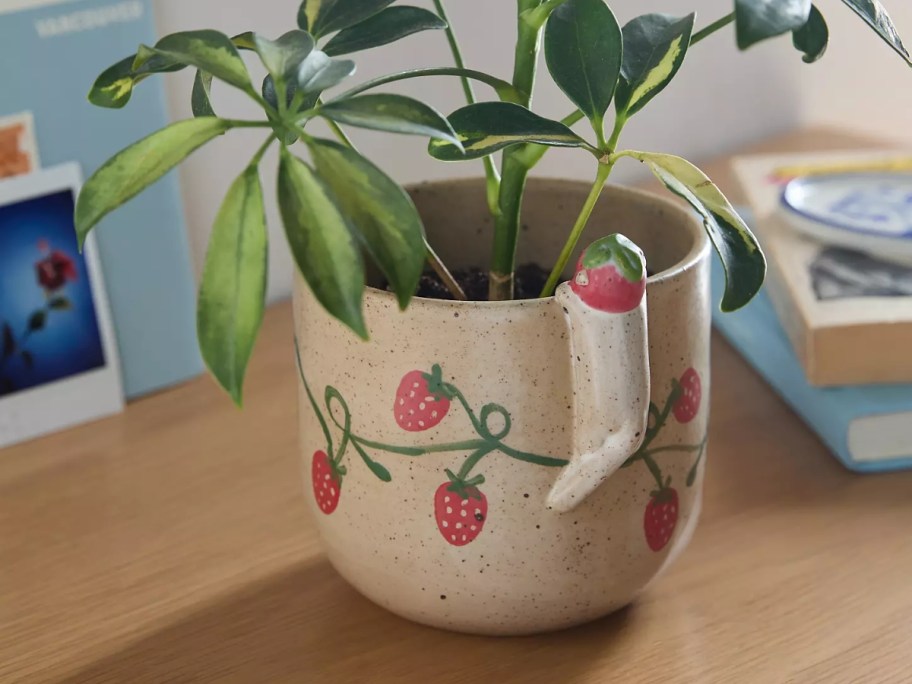 Peeking Animal Planter on table with potted plant