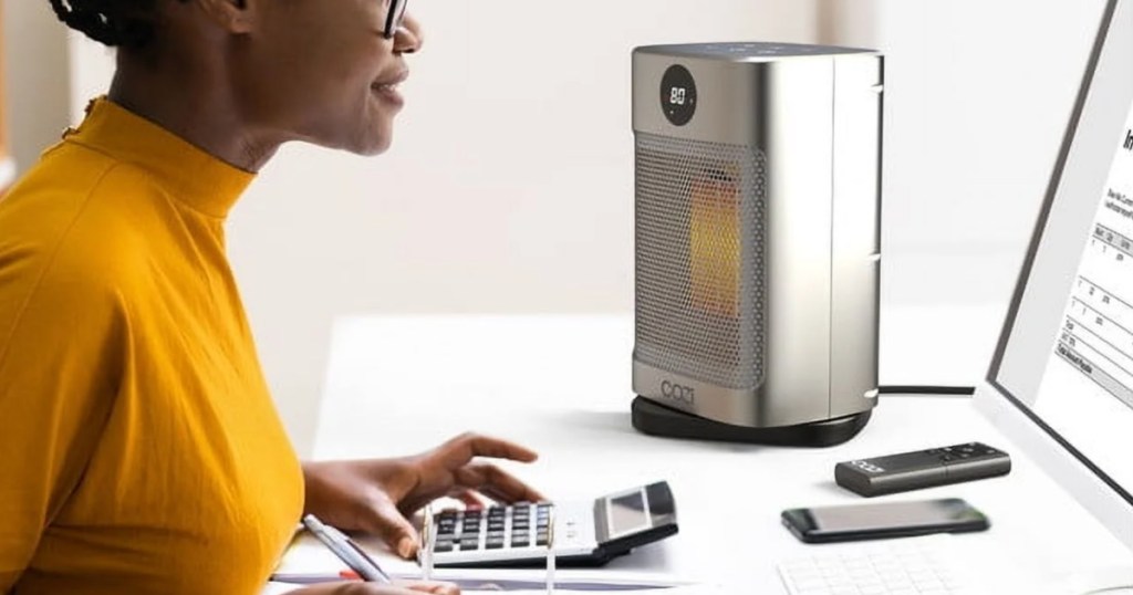 woman working at desk next to Portable Oscillating Space Heater