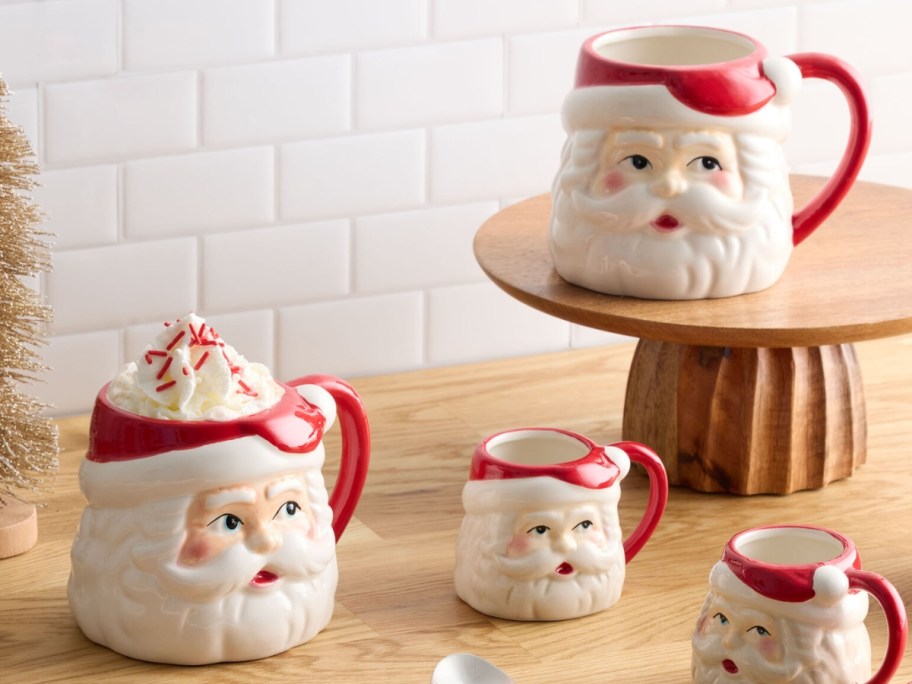 World Market Jolly Santa Ceramic Mug with mini mugs on table