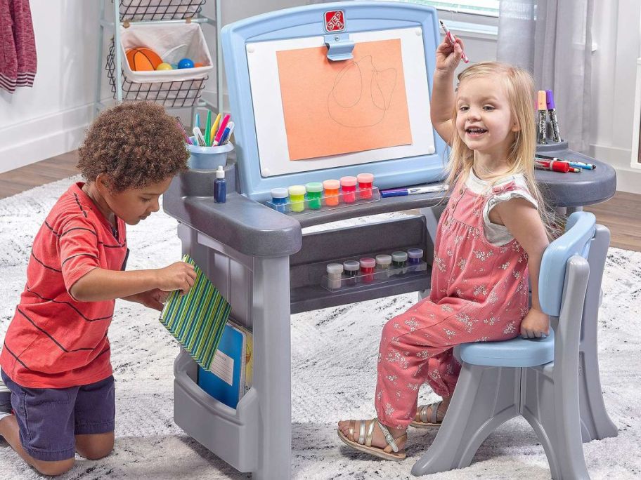 2 Kids playing with a Step2 Art Desk