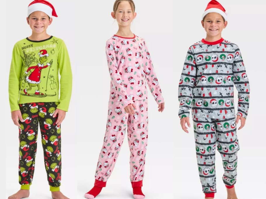 kids wearing the grinch, hello kitty, and the nightmare before christmas pajama sets