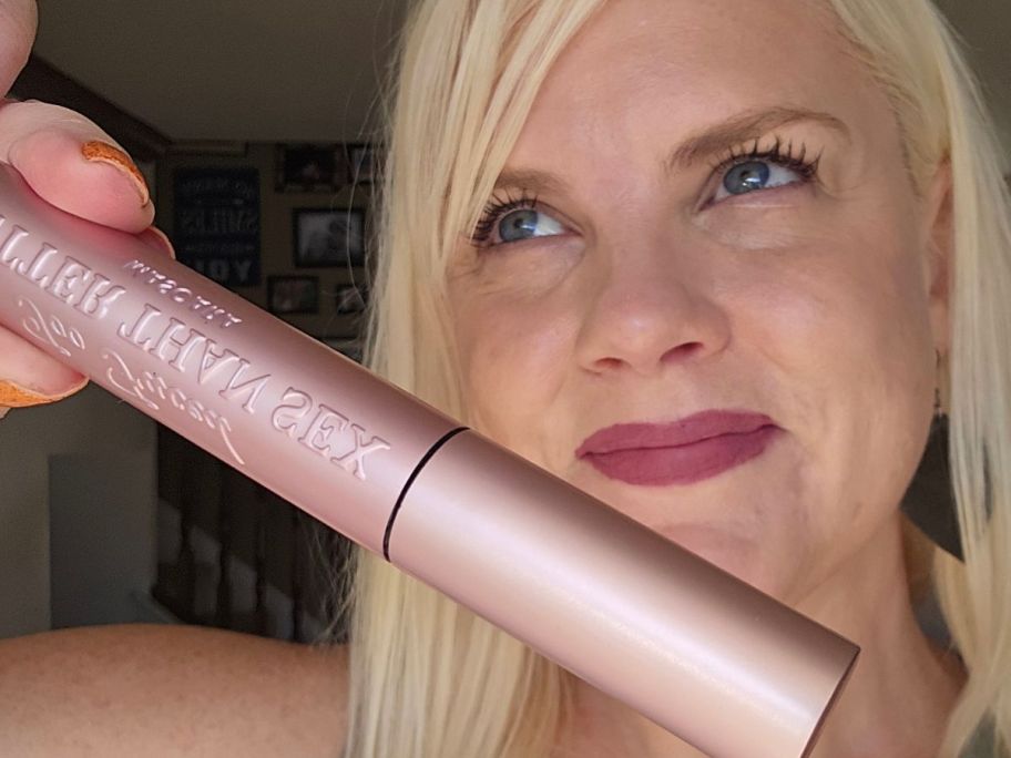 Woman holding a too faced better than sex mascara in front of her face