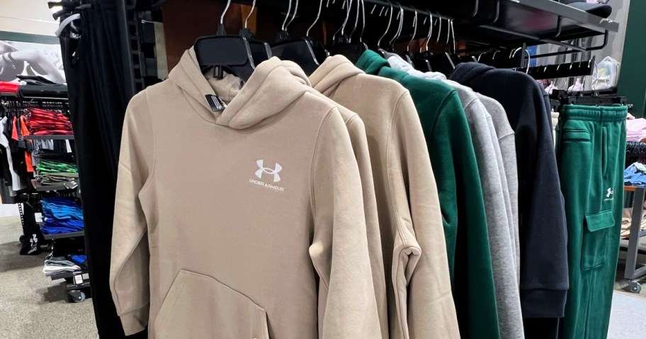 Under Armour tan colored Fleece Hoodie hanging in store