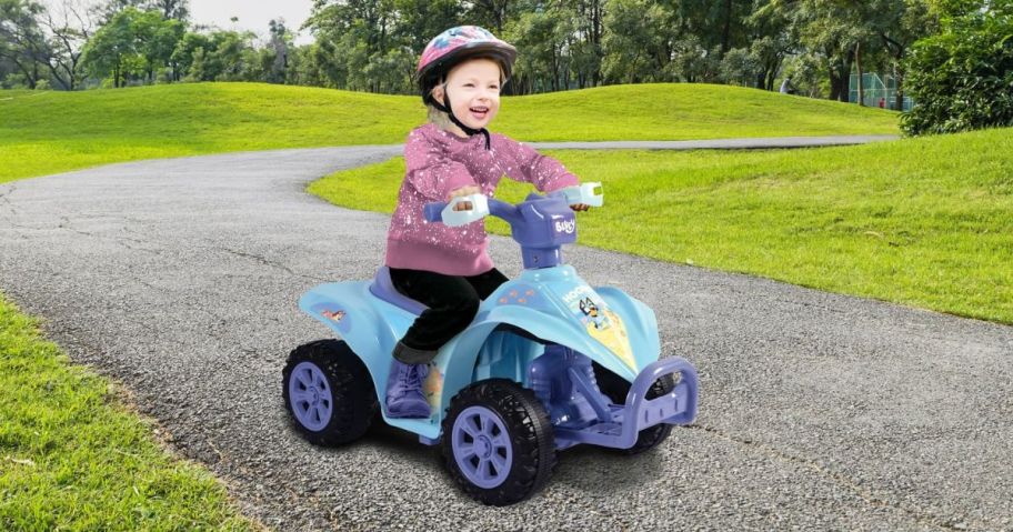 Little girl riding on a Bluey 6V ATV quad