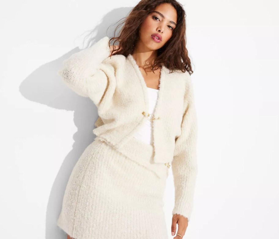 woman modeling white boucle cardigan