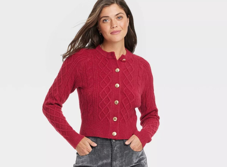 woman modeling red knit cardigan with gold button