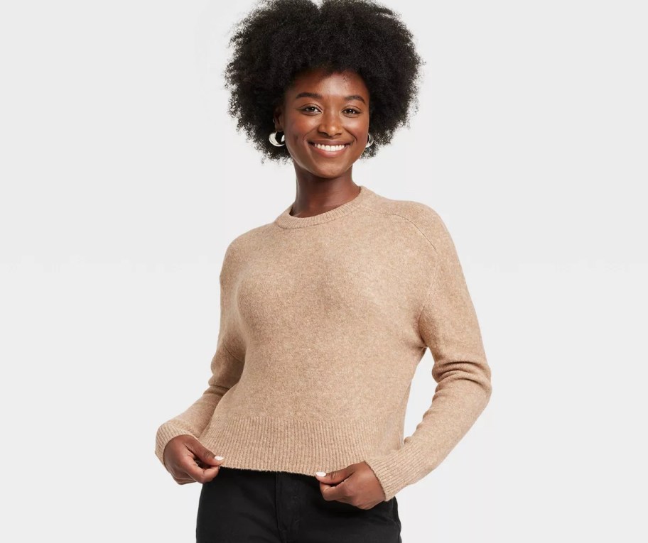 woman modeling tan colored sweater