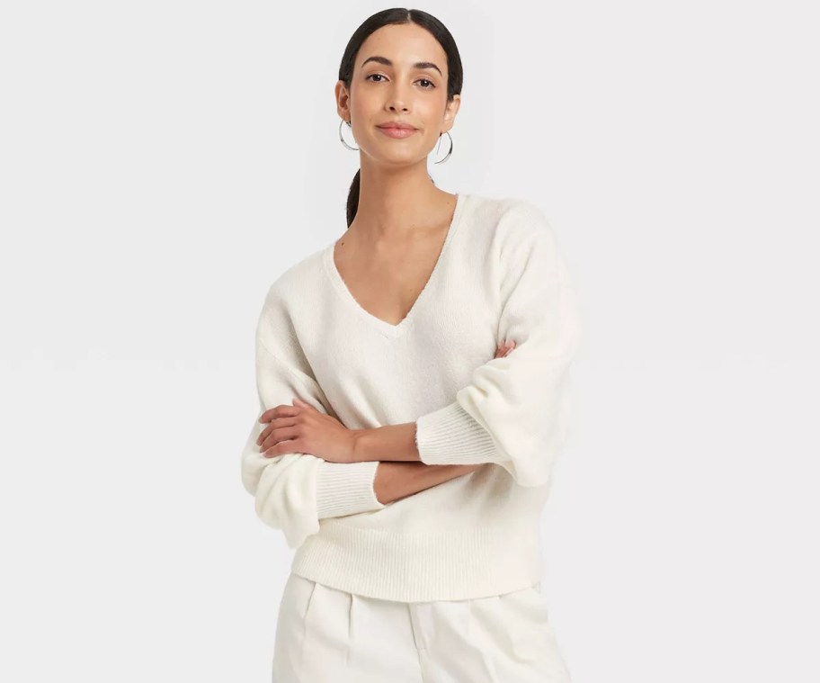 woman modeling white v neck sweater