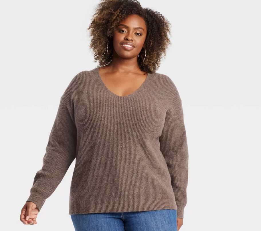 woman modeling brown sweater