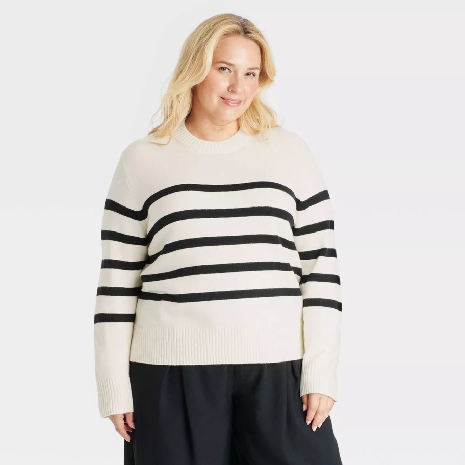 woman modeling white stripe pullover sweater