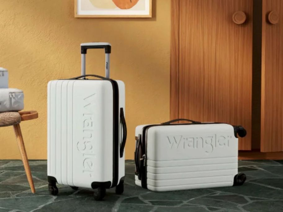 Two wrangler rolling carry on suitcases