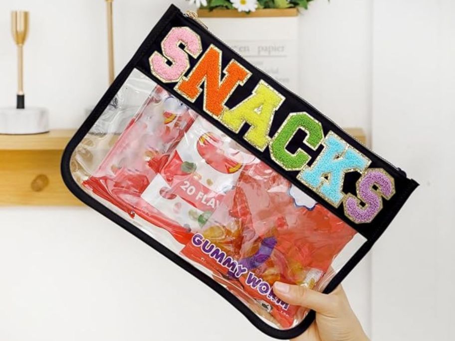 Zipper Pouch - Black Snacks in hand with snacks in it