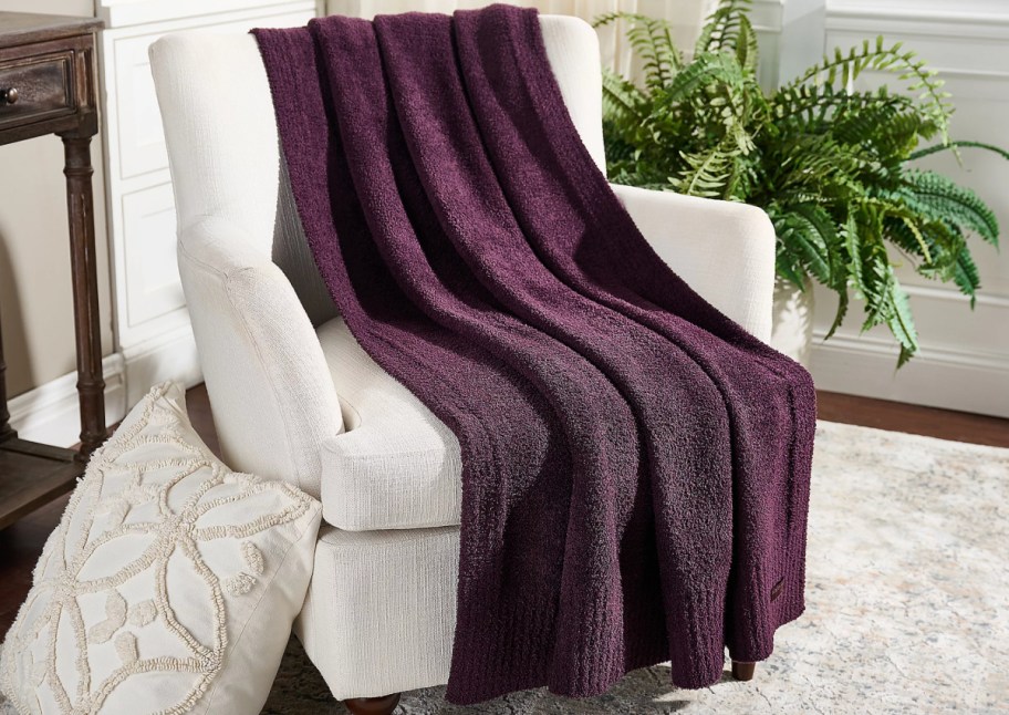 purple blanket on white chair