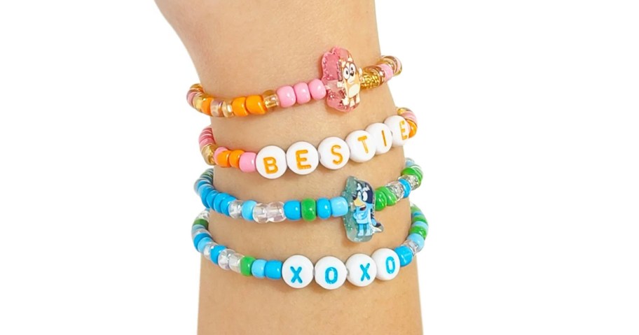 wrist with 4 orange and blue bluey bracelets 