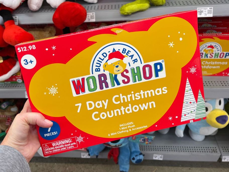 a womans hand holding a build a bear advent calendar