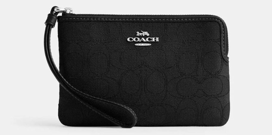 a black signature fabric coach wristlet stock image