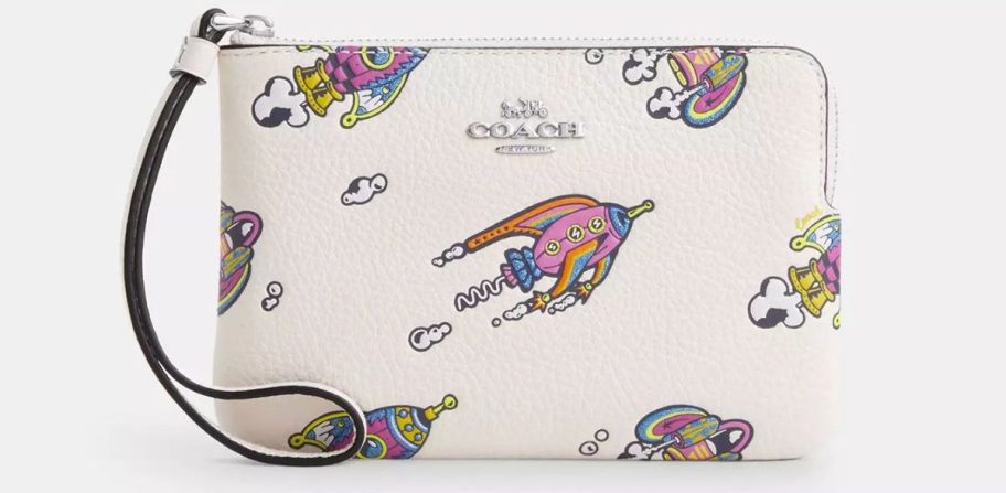 a white leather coach wristlet with rocket print stock image