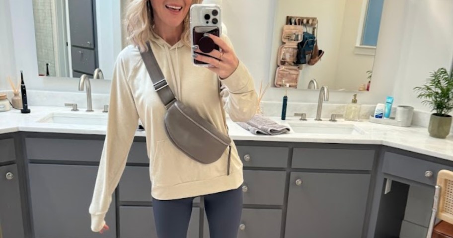 woman in sling bag taking selfie