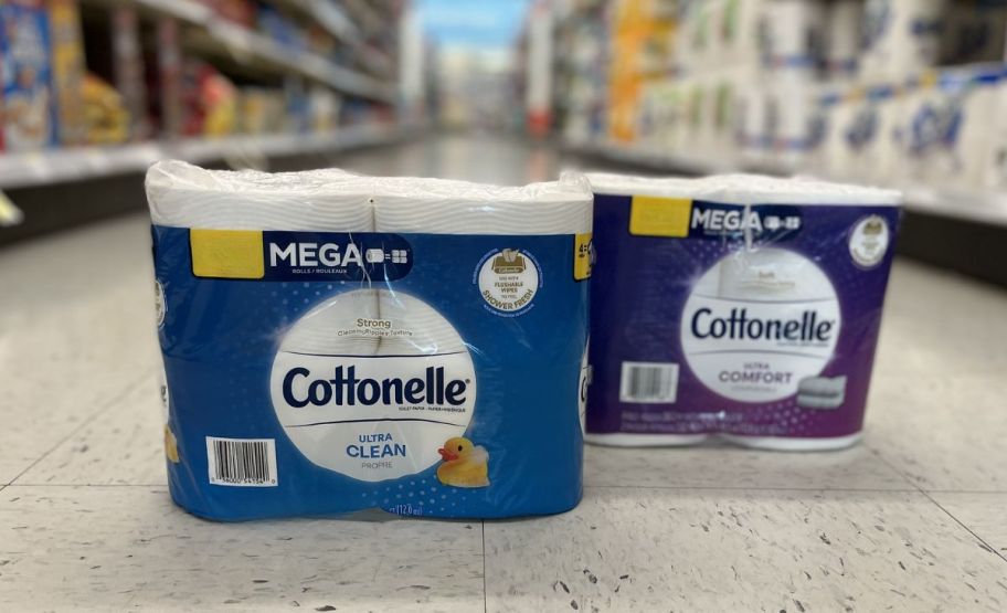 2 packages of cottonelle toilet paper on the floor in a store aisle