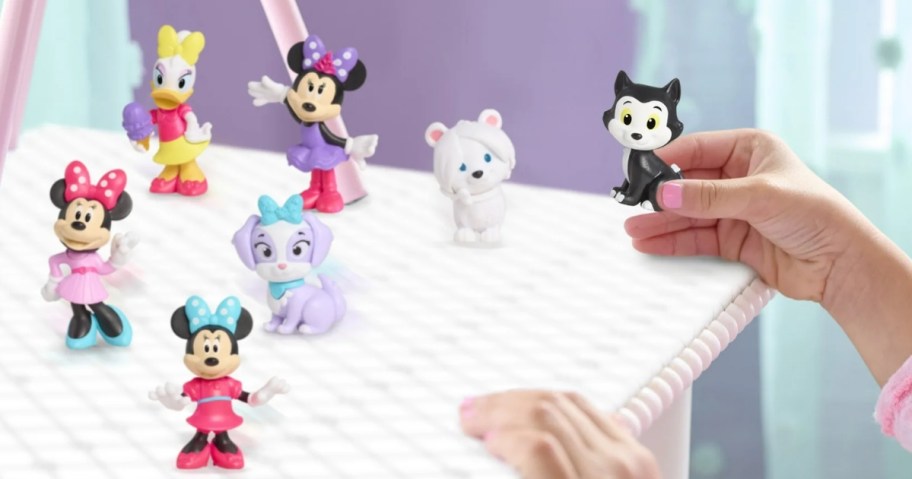 little girl playing with a Disney Minnie Mouse & pets mini figure set