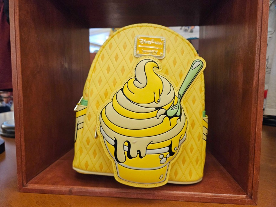 disneyparks dole whip loungefly backpack displayed in a store