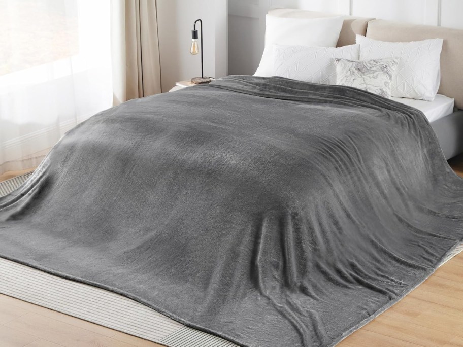 extra large blanket in gray displayed on the bed