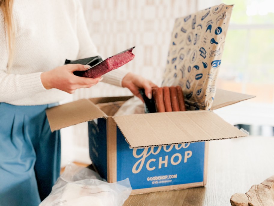 woman unpacking good chop meat delivery box