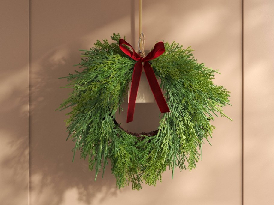 green wreath with red bow at the top displayed a back drop