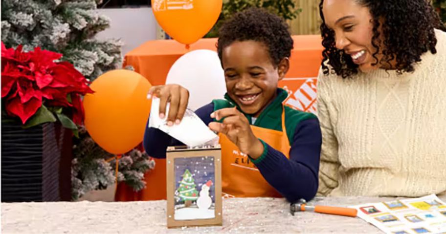 adult and child making home depot holiday snow globe in store