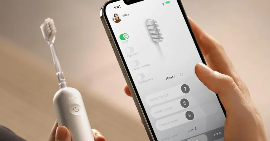 hand holding cell phone and smart toothbrush