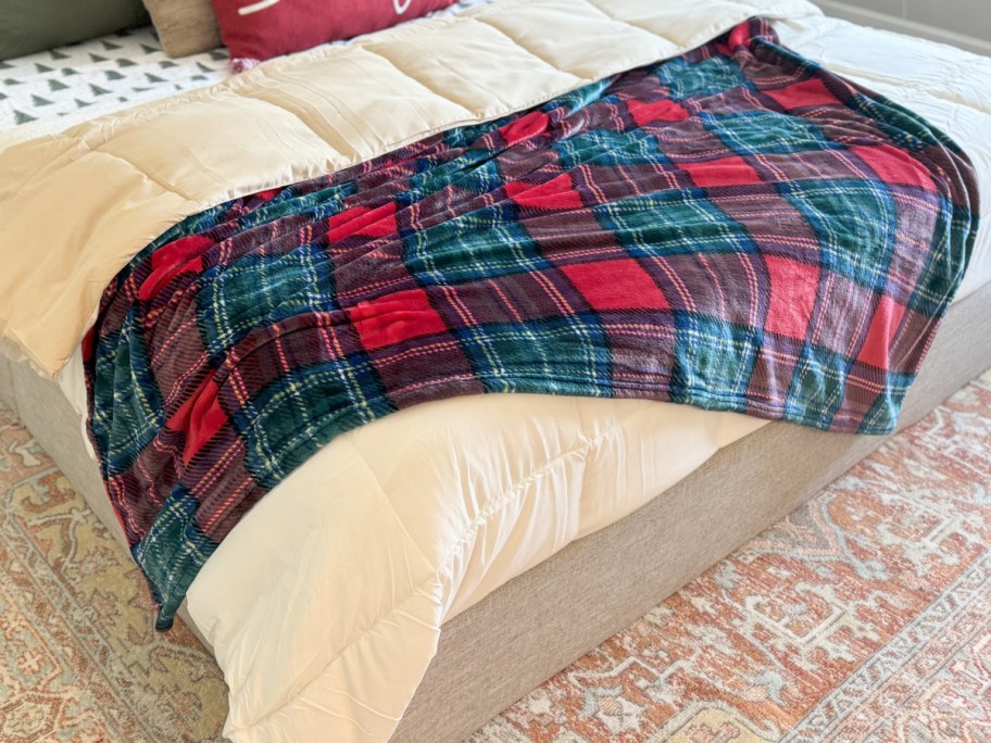 red and green plaid throw blanket on bed