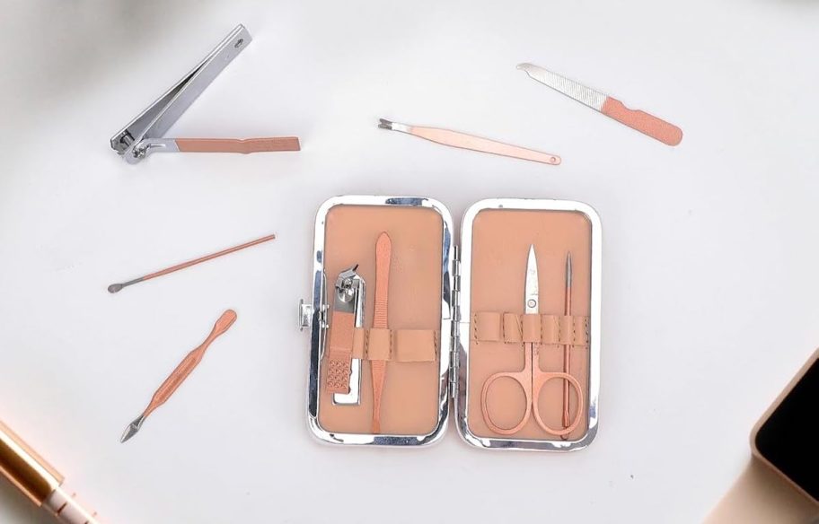 pink manicure set spread out on white countertop