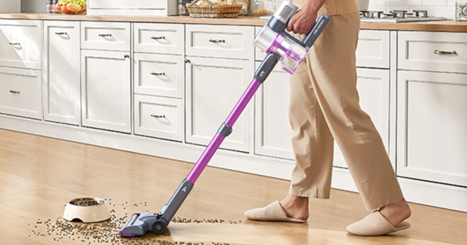 person vacuuming hardwood floor