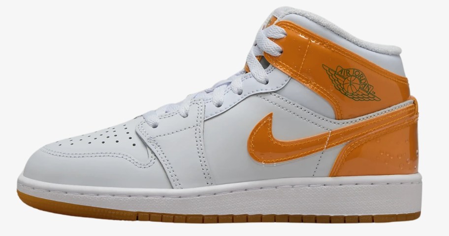 kid's Nike Air Jordan mid shoe in white with orange accents