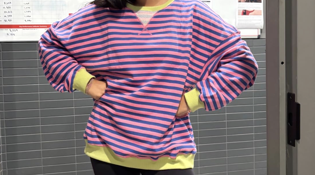 woman wearing oversized striped sweatshirt 