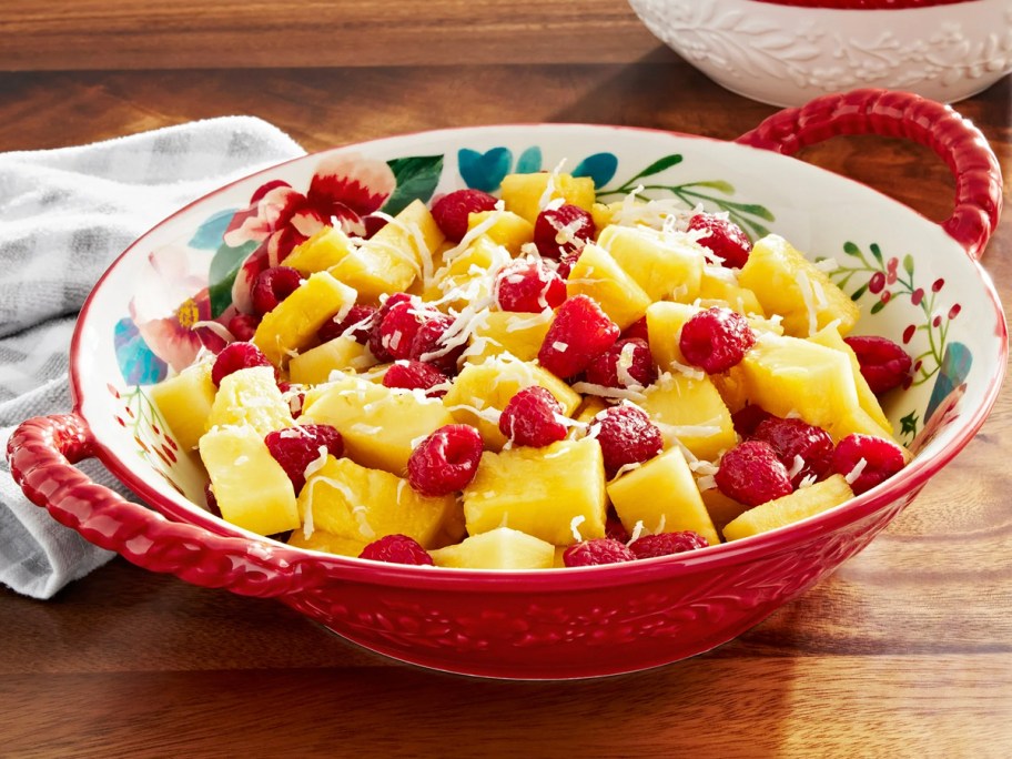 red bowl on table with fruit