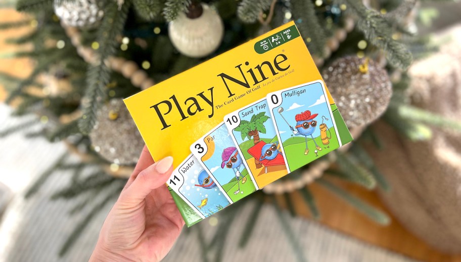 play nine card game in front of christmas tree