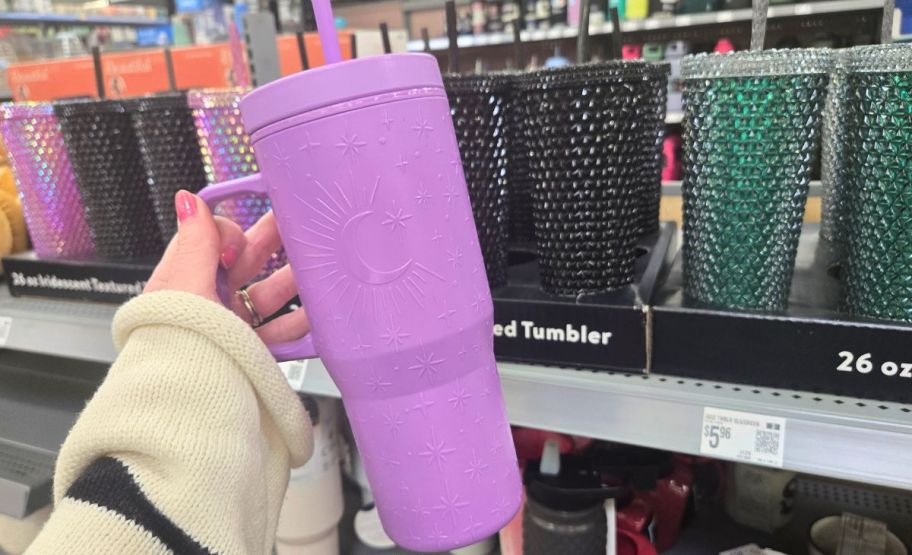 a womans hand holding a Purple 40oz tumbler