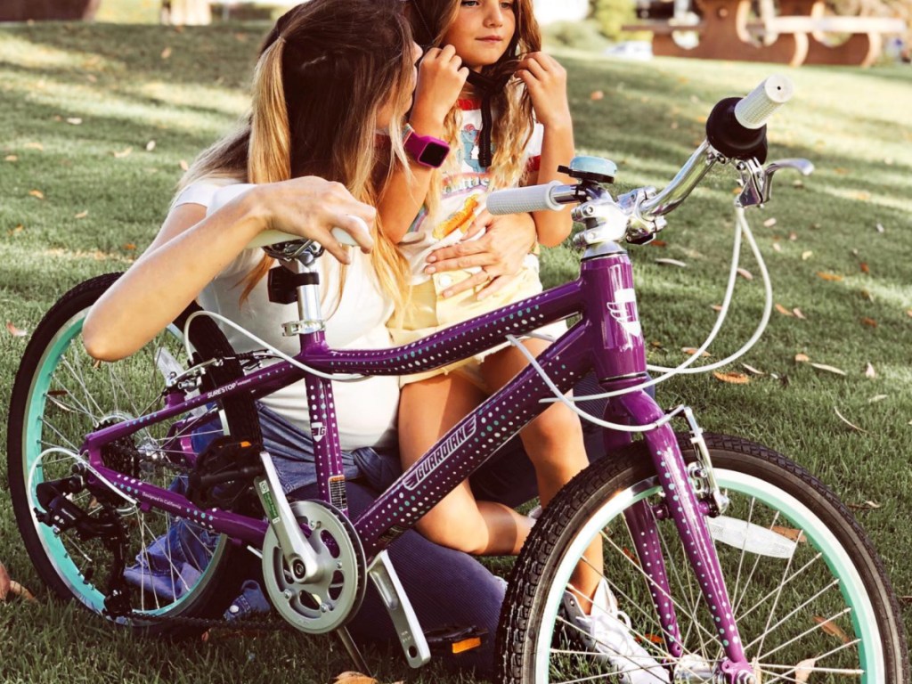 woman and little girl next to purple guardian bike