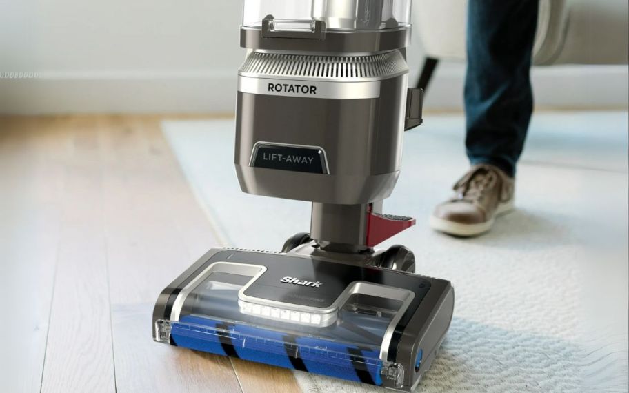 a woman's feet behind a shark vacuum