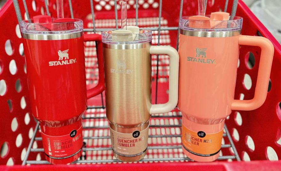 three stanley elf tumblers in a target shopping cart 