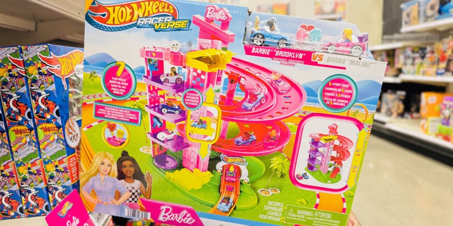 hand holding barbie hot wheels playset