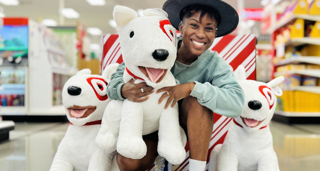 Cam holding huge Bullseye dog plush in Target